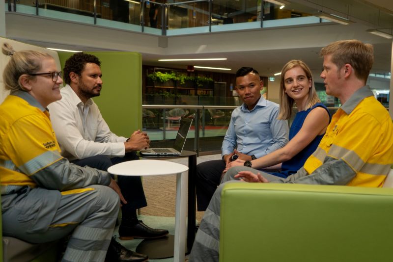 Group of employees sitting on a couch together