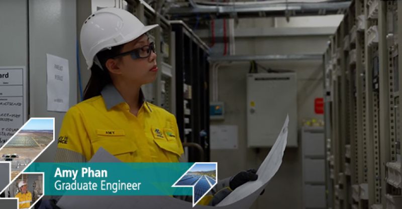 Energy Queensland employee Amy Phan looking at electrical equipment