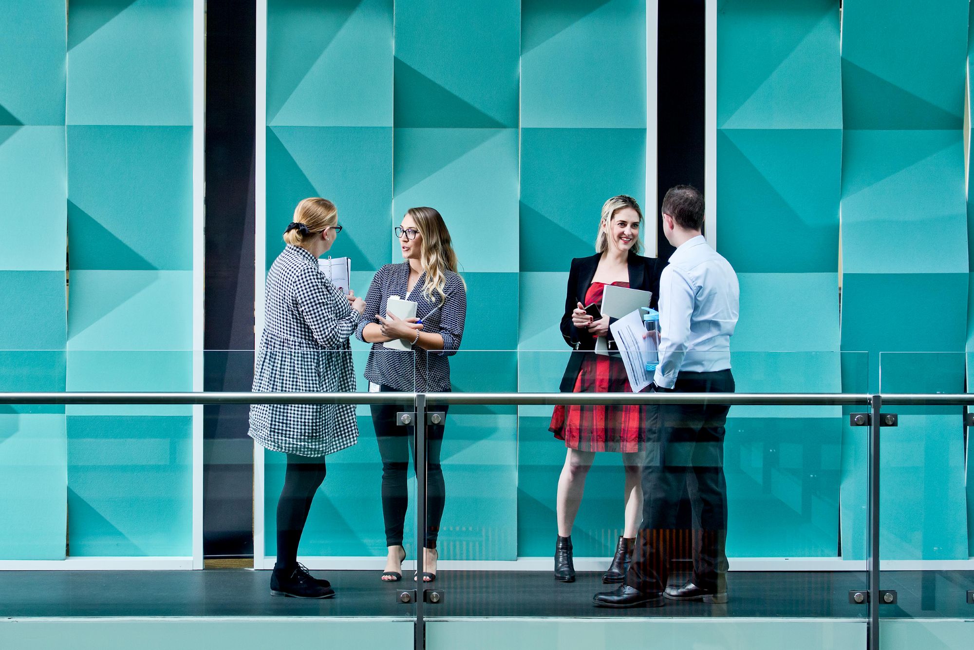 Employees in corridor blue background