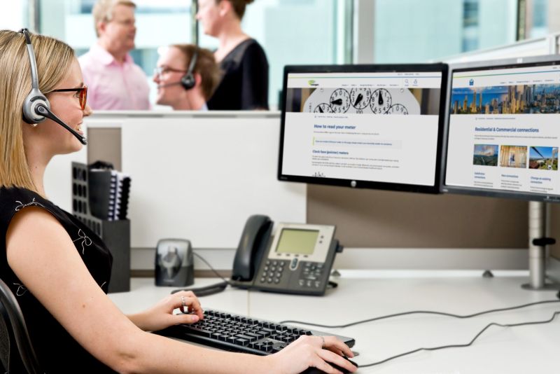 Worker at desk computer with screens