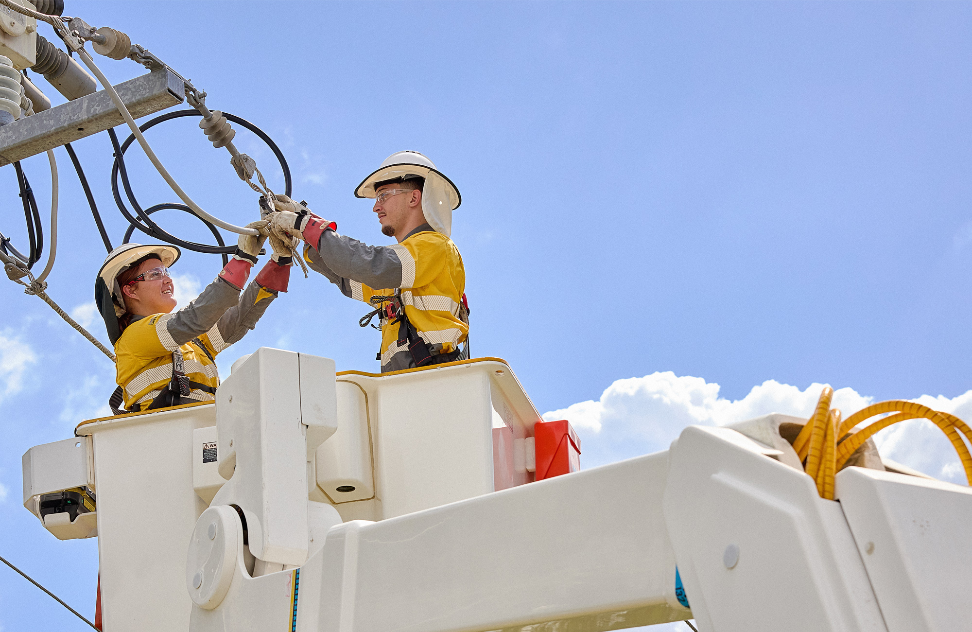 Two field crew working on powerlines in truck