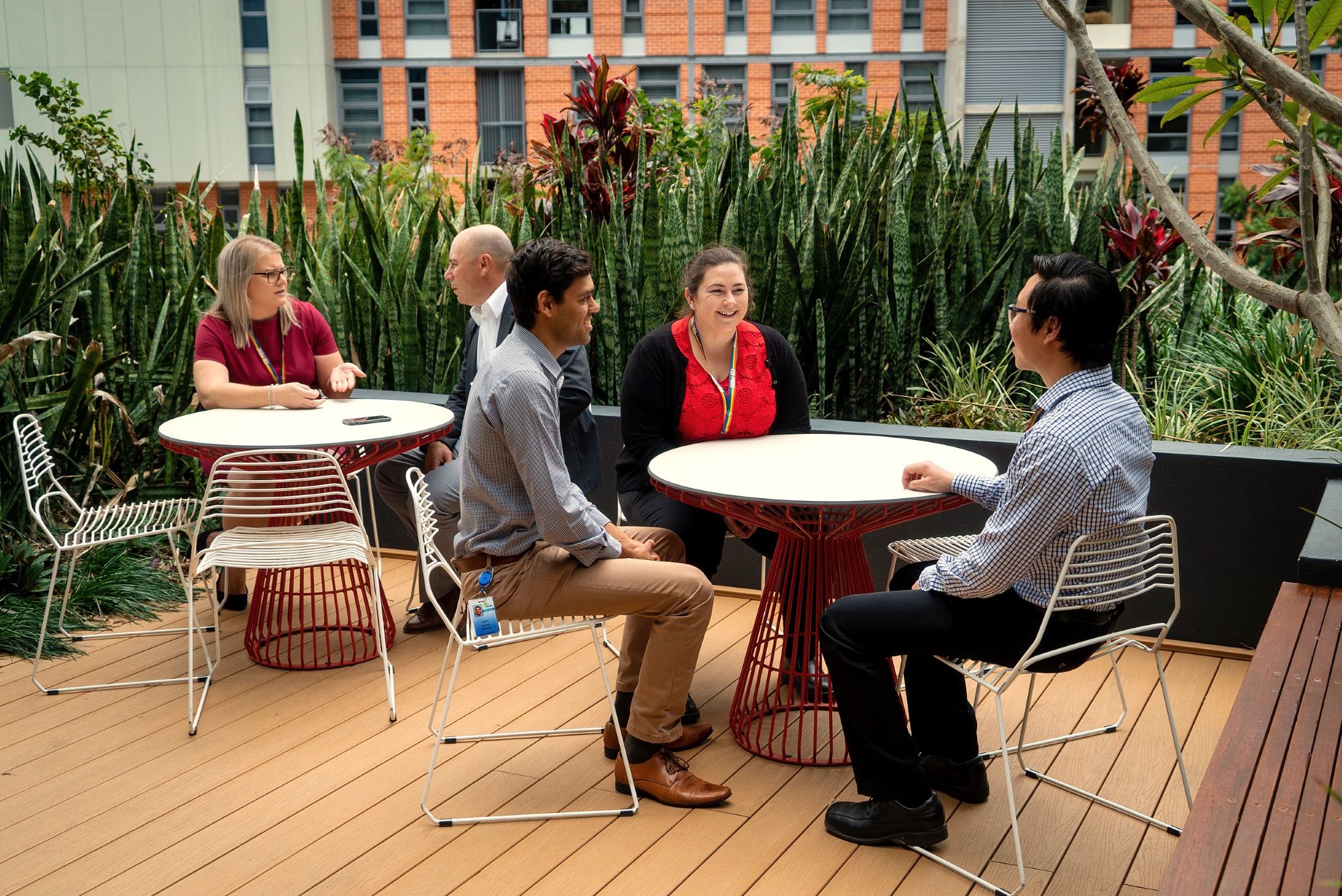 Workers outside sitting at tables