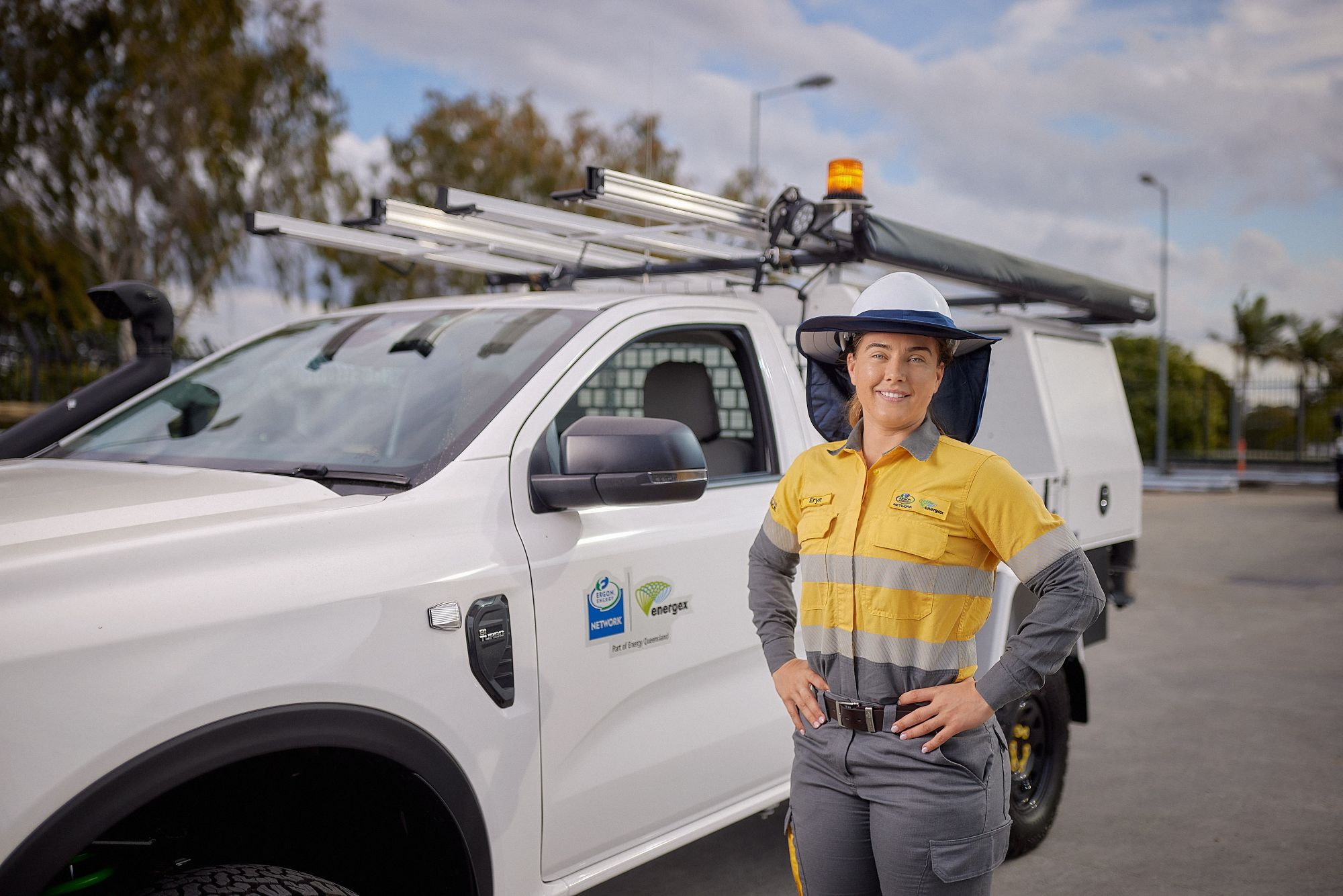 Female worker standing beside work ute