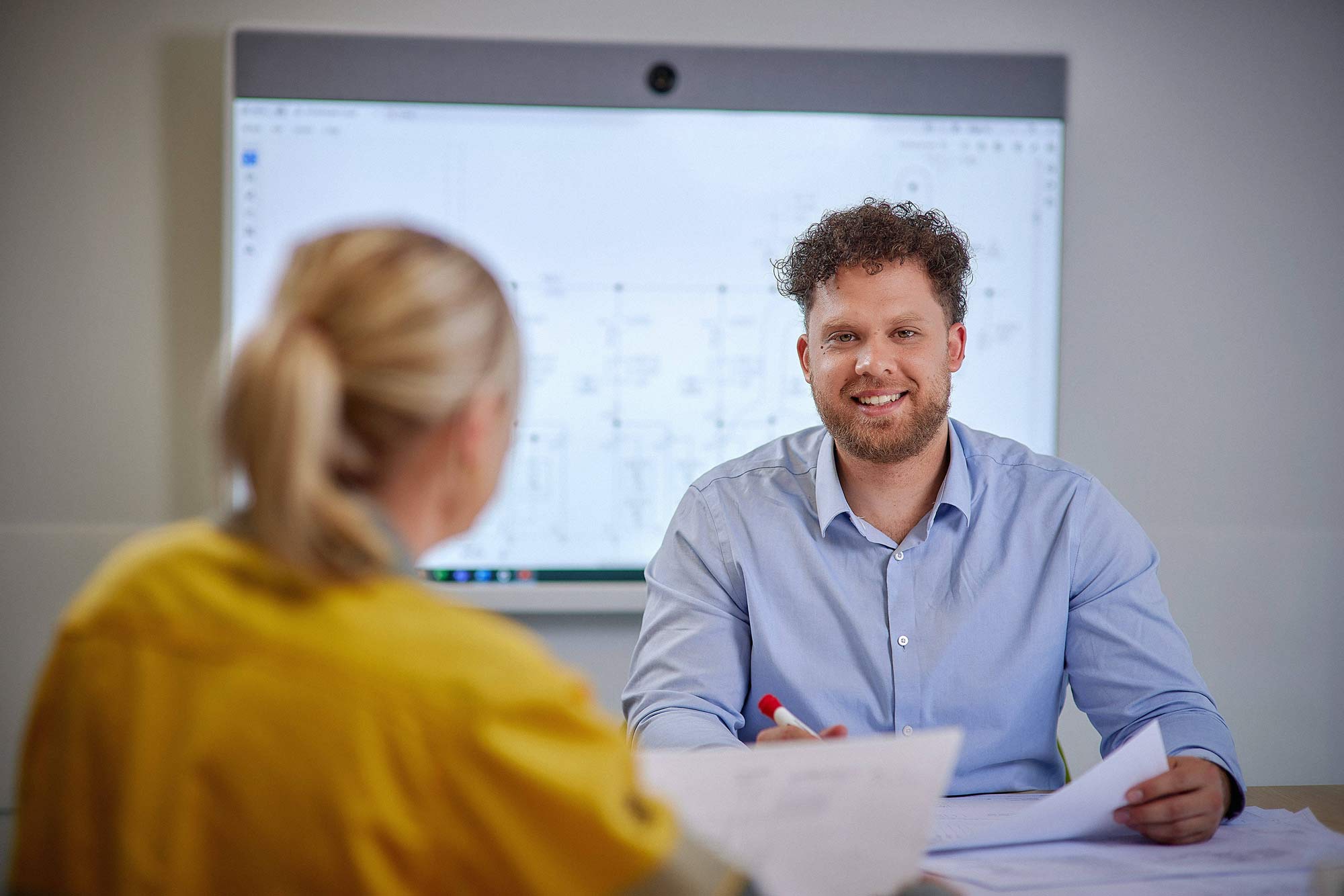 Conor and worker at desk