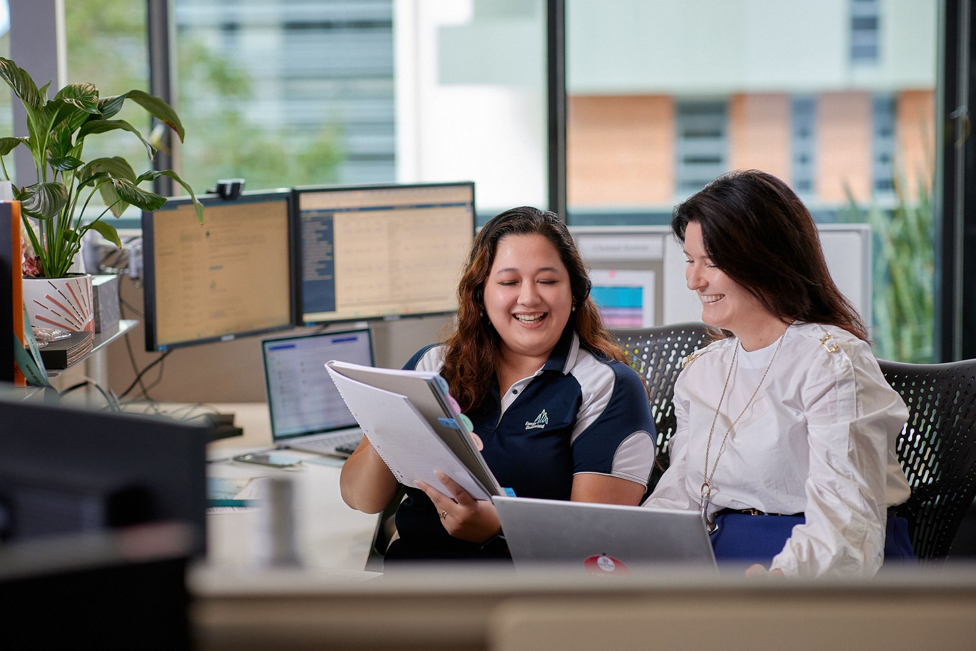 Two female employees in meeting room