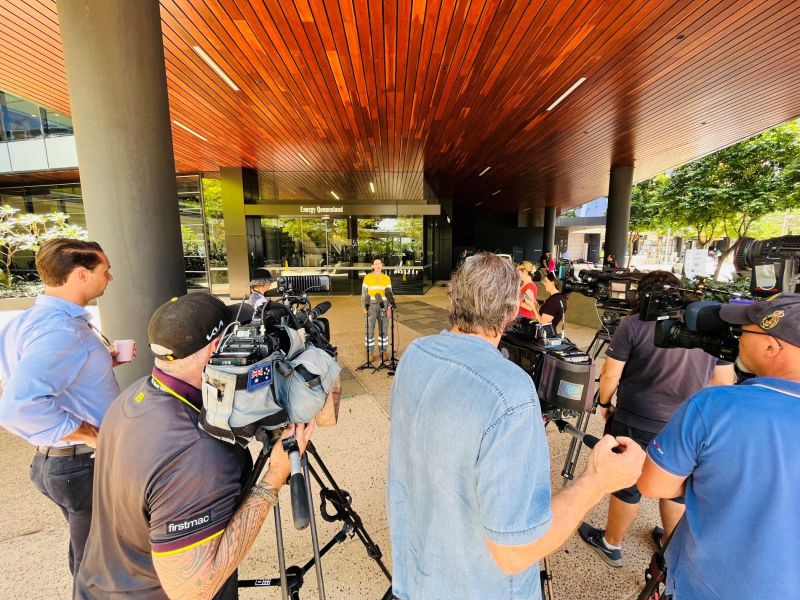 Employee out the front of building with media cameras