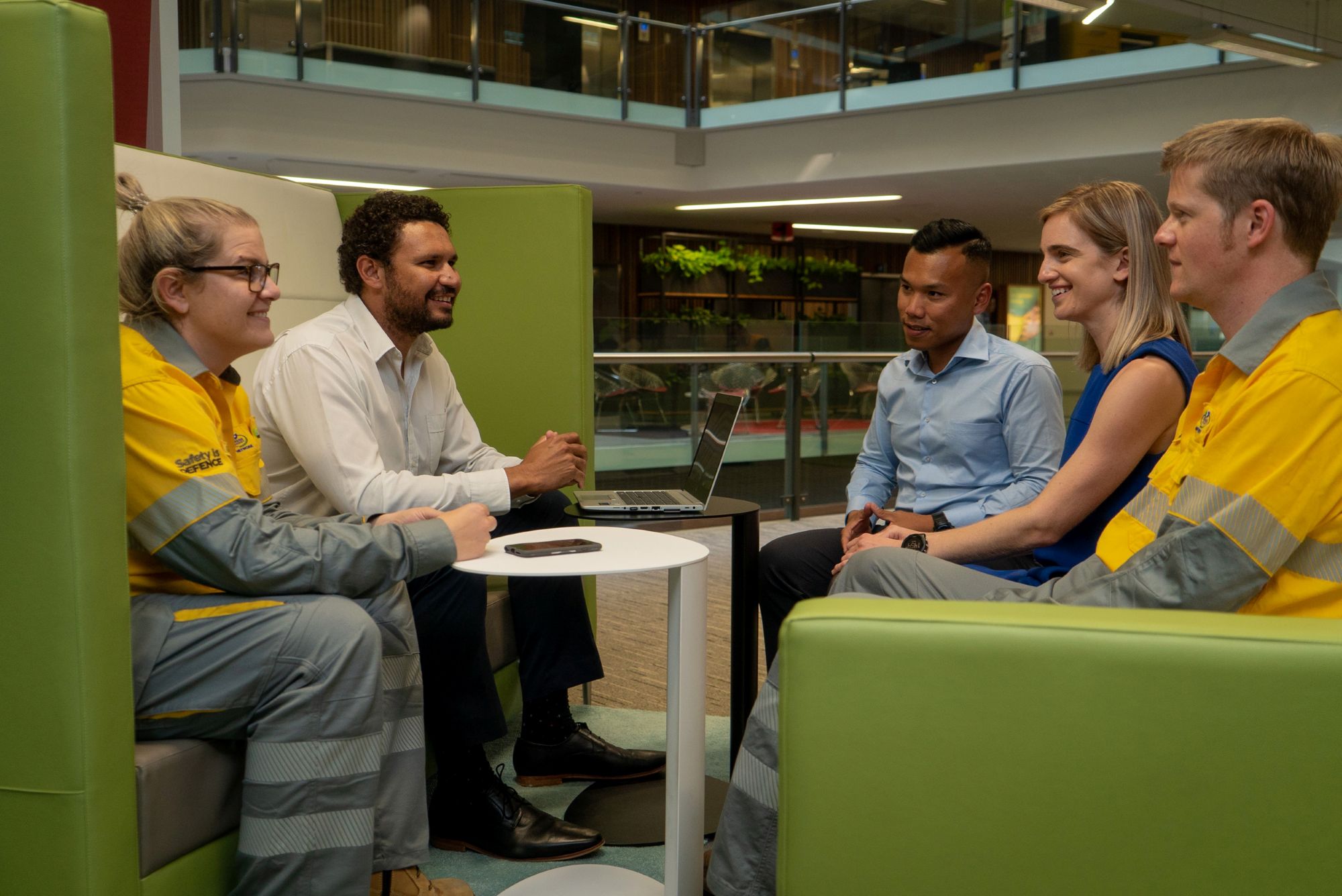 Employees sitting on green lounge office building