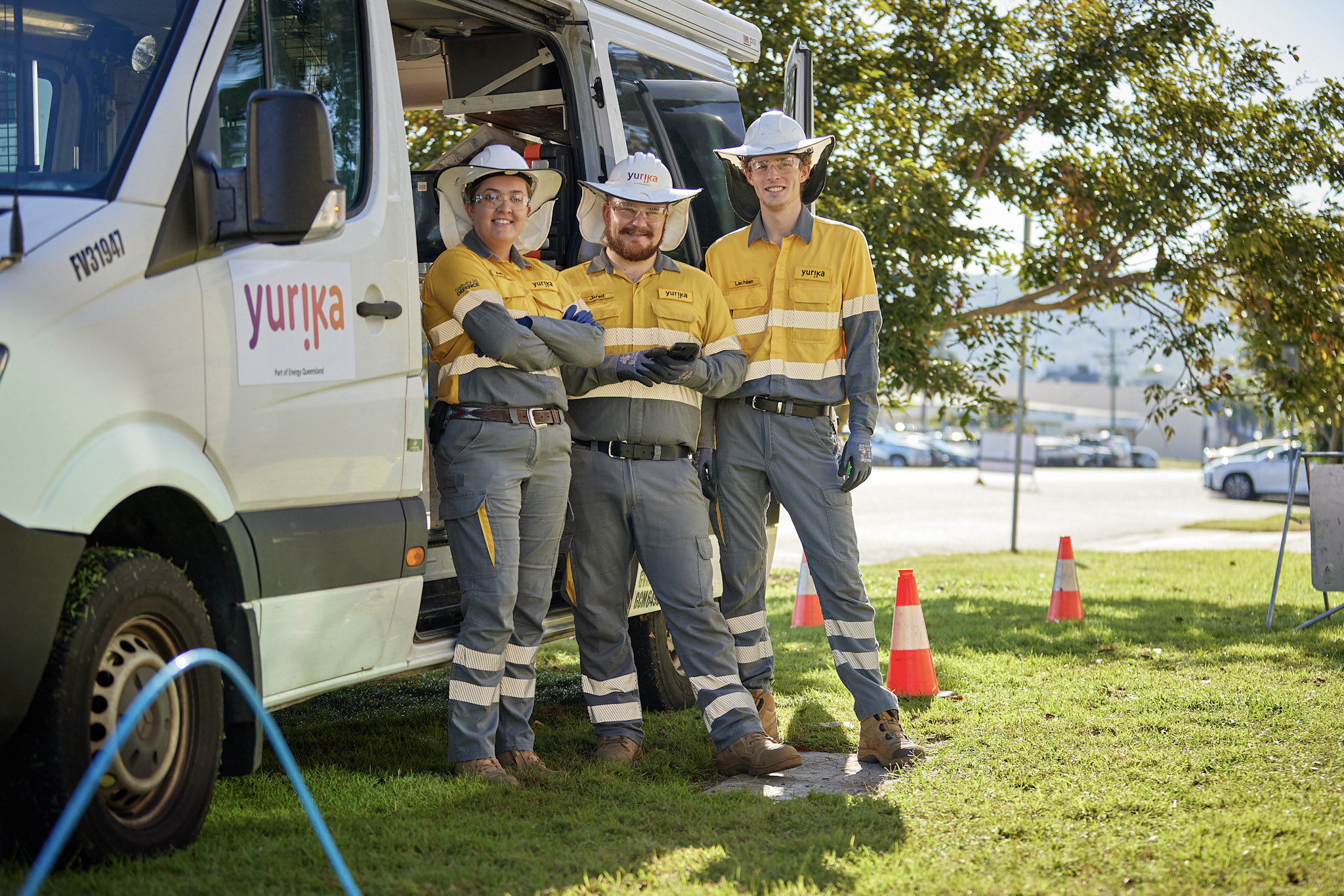 Yurika workers leaning against car