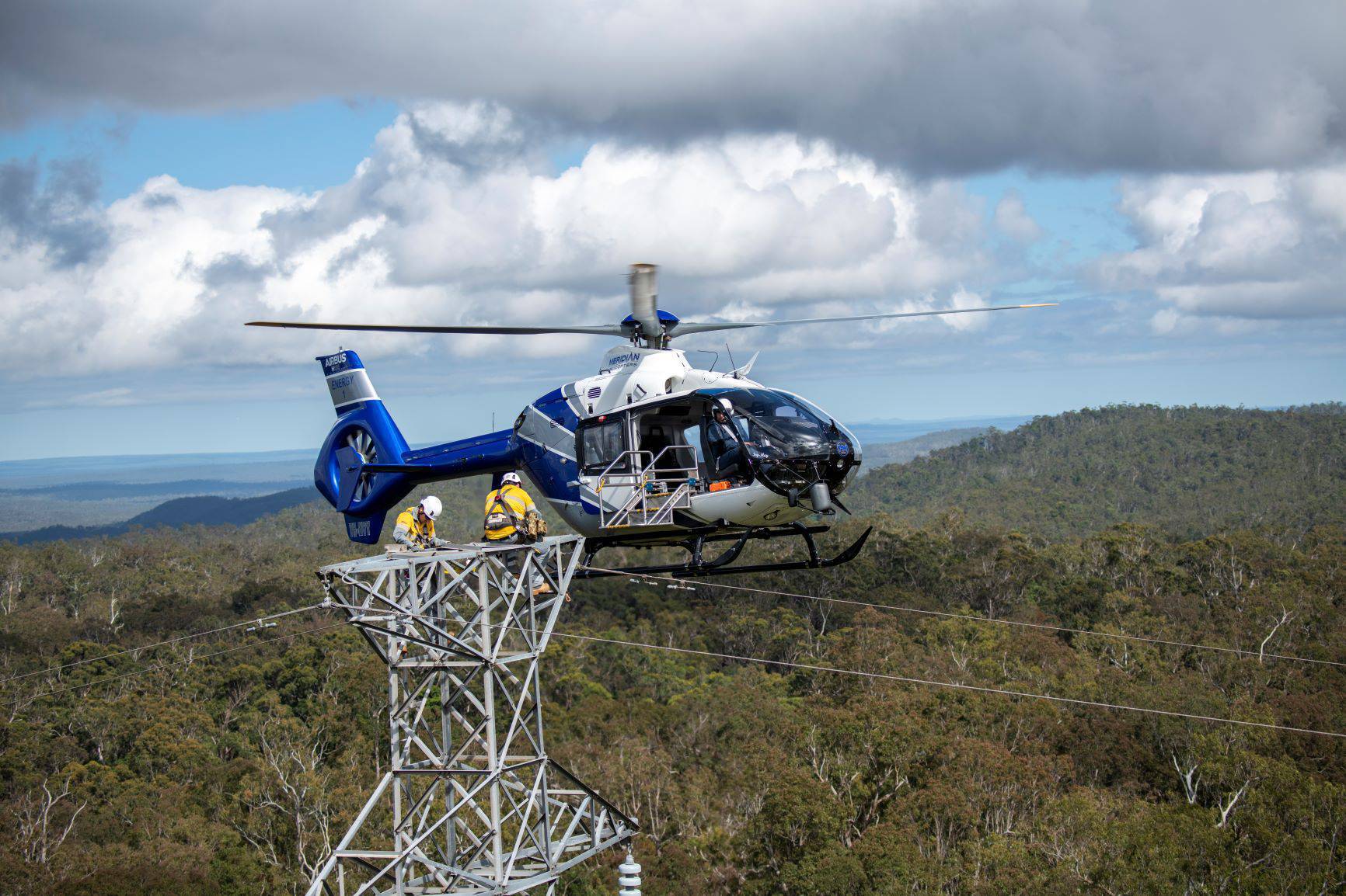 Workers on powerline with helicopter
