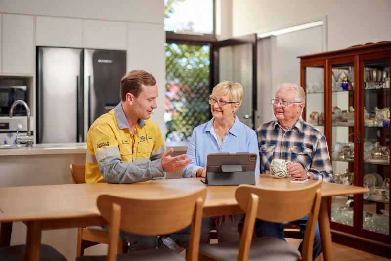 Employee talking to customers at table