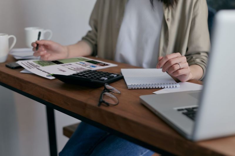 Lady calculating a bill at desk